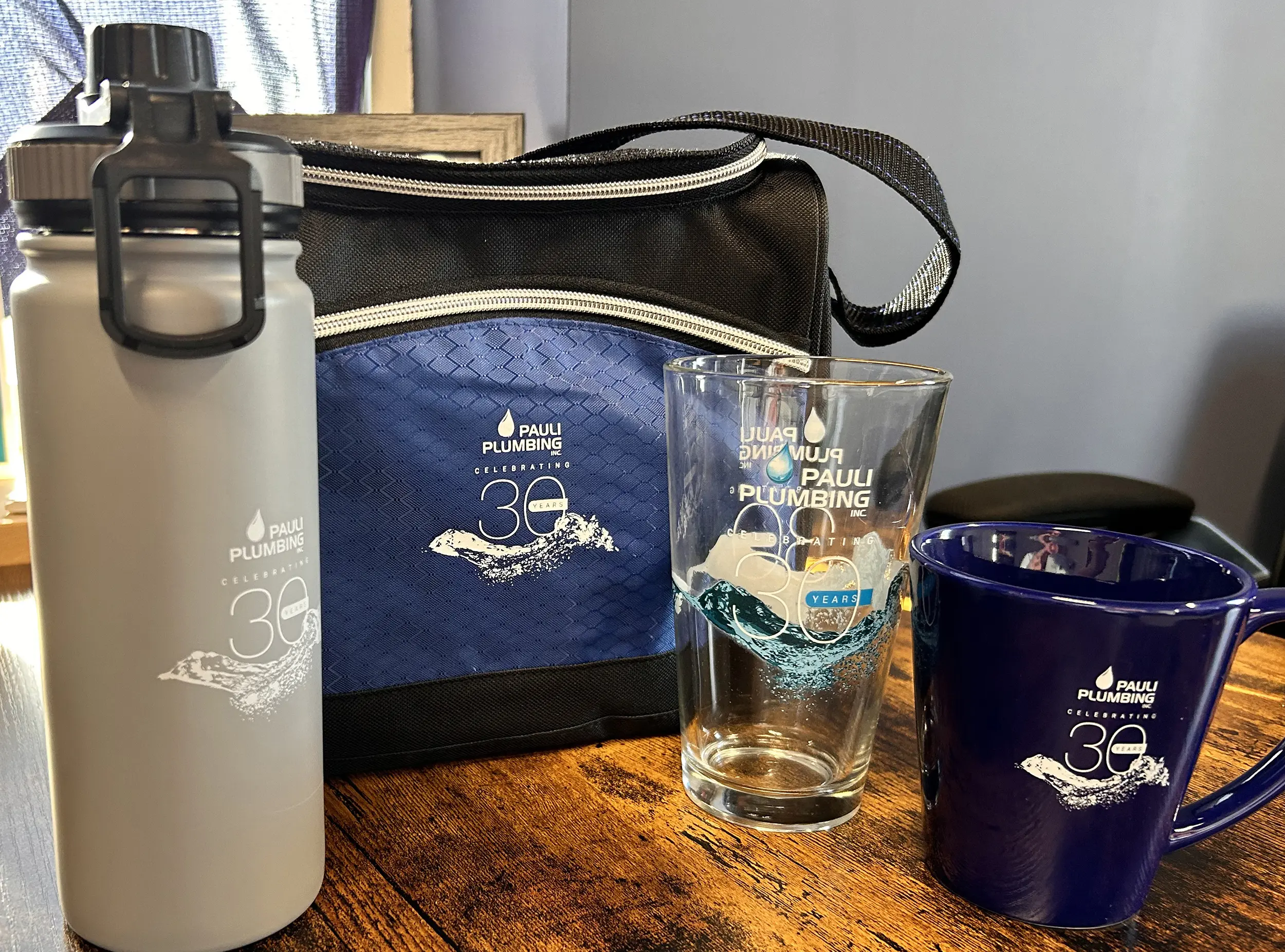 Pauli Plumbing Promo items - glasses mugs and water bottles